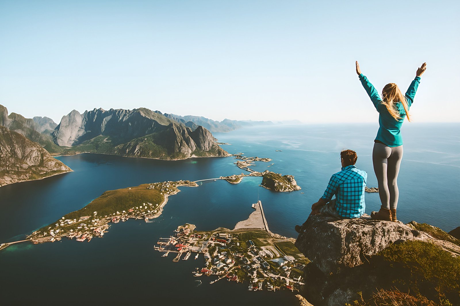 Couple Hiking to Stunning Coastal Viewpoint Overlooking Island and Fjords