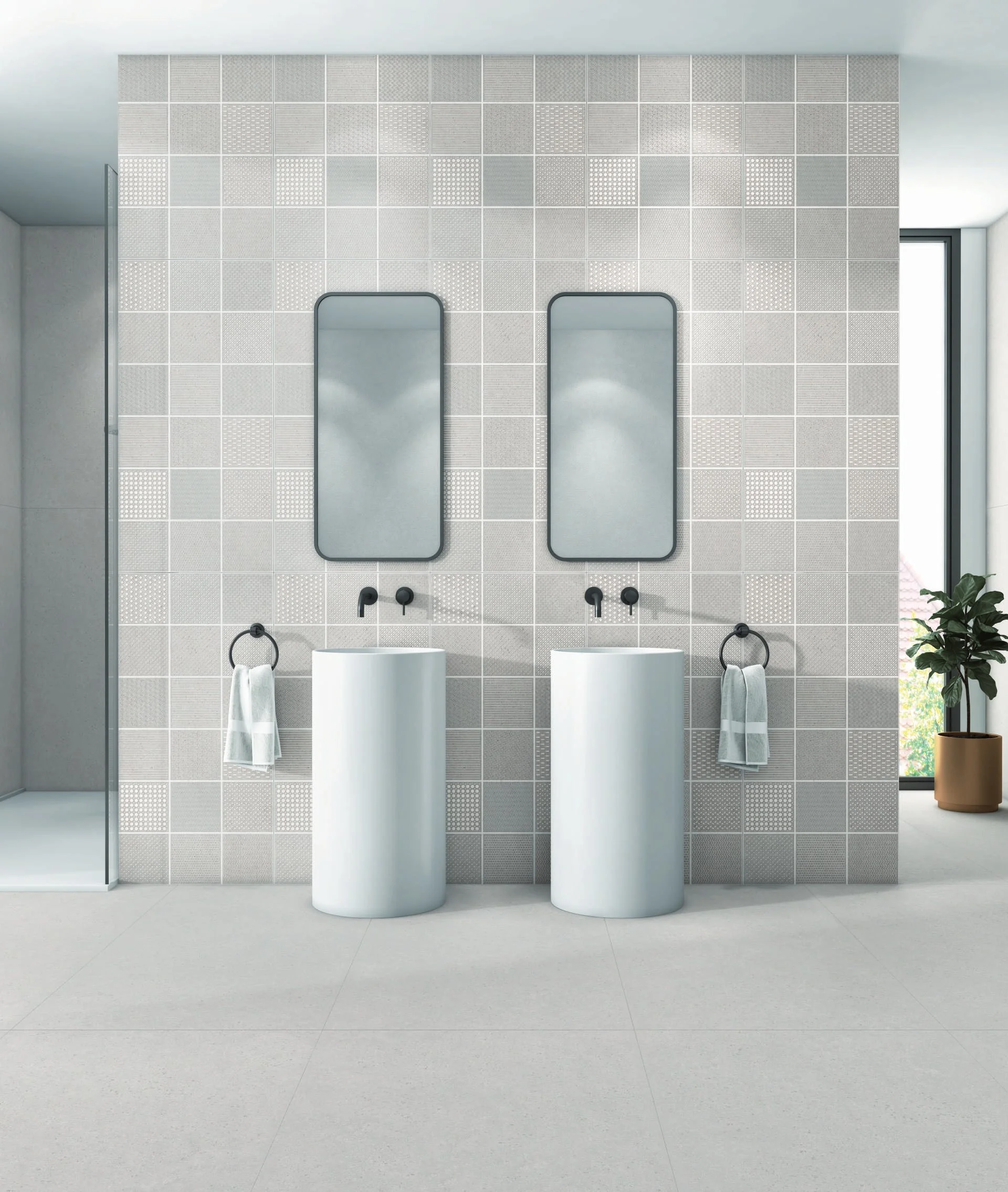 Gray geometric tile bathroom with freestanding white sinks.
