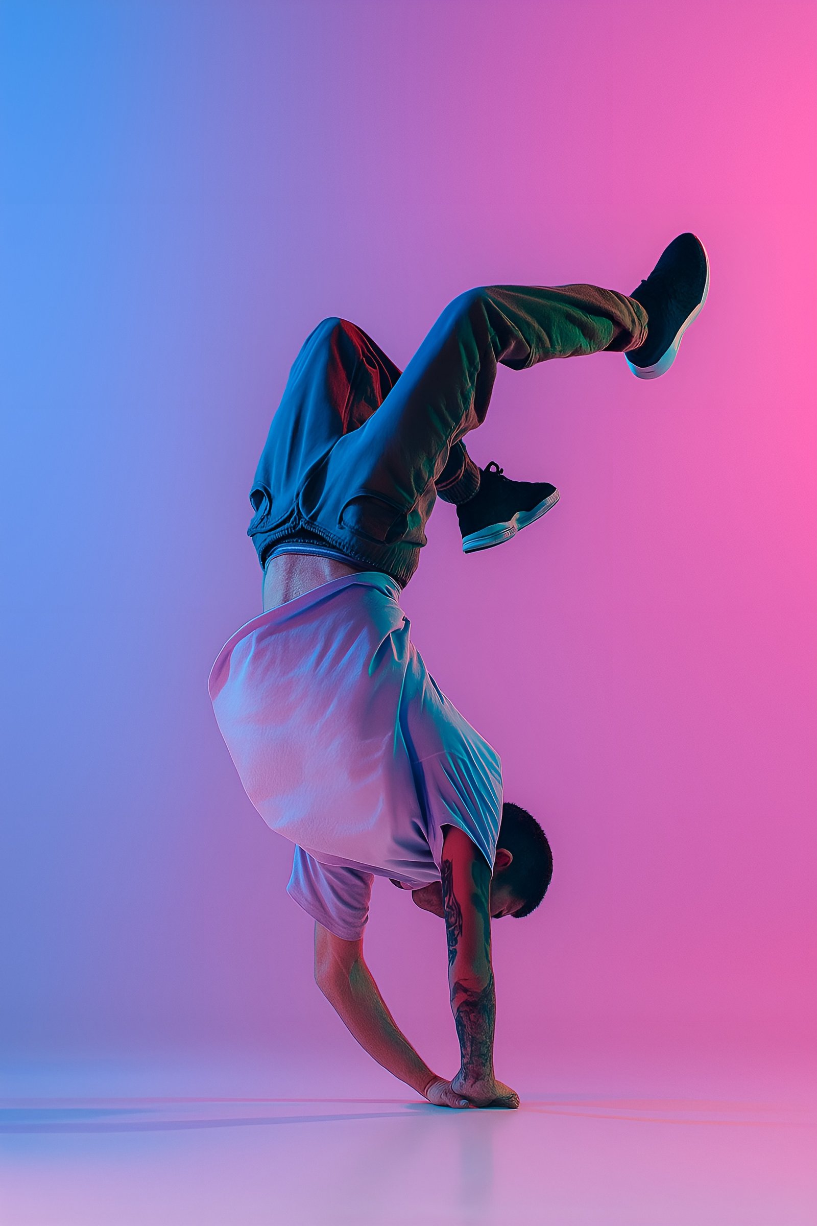 Man Performing Handstand in Vibrant Pink and Blue Neon Lighting