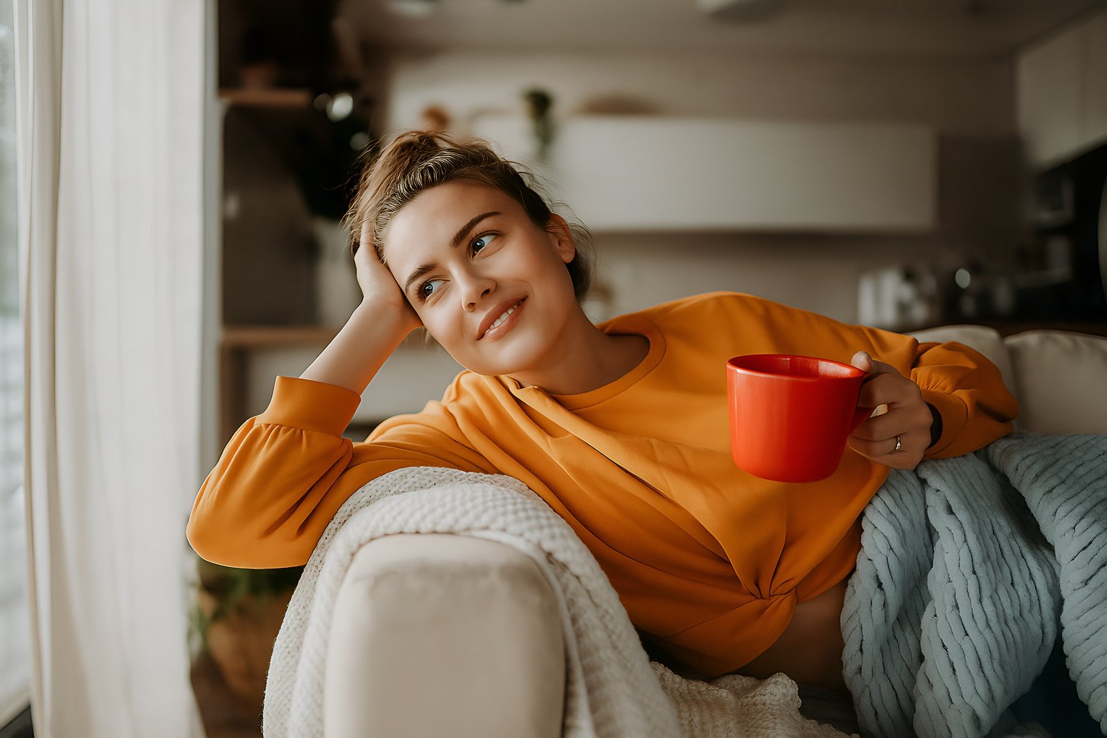 Relaxed Woman Enjoying a Cozy Moment at Home With a Warm Mug
